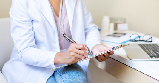 A doctor filling a paper