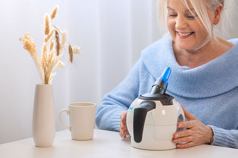 A woman holding the WellO2 device